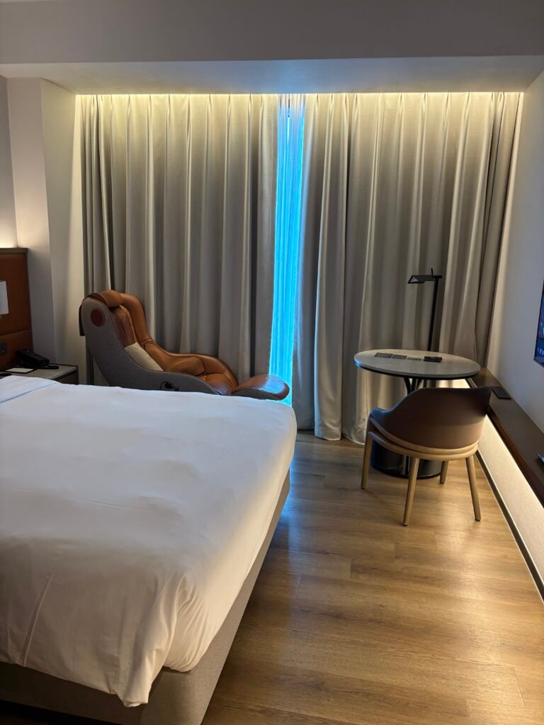 Compact guest room with a massage chair at AC Hotel Seoul Gangnam