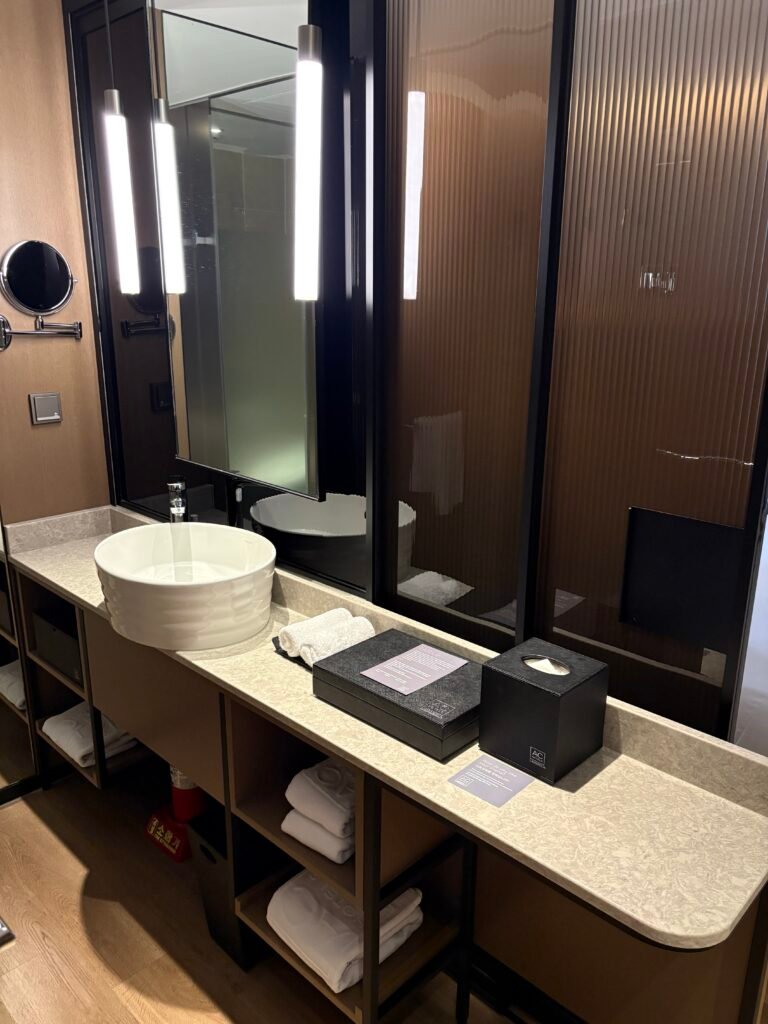 Semi-open vanity with a large mirror, sink and storage in the guest room