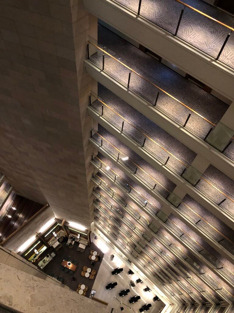 Multi-storey internal atrium viewed from an upper guest-room corridor