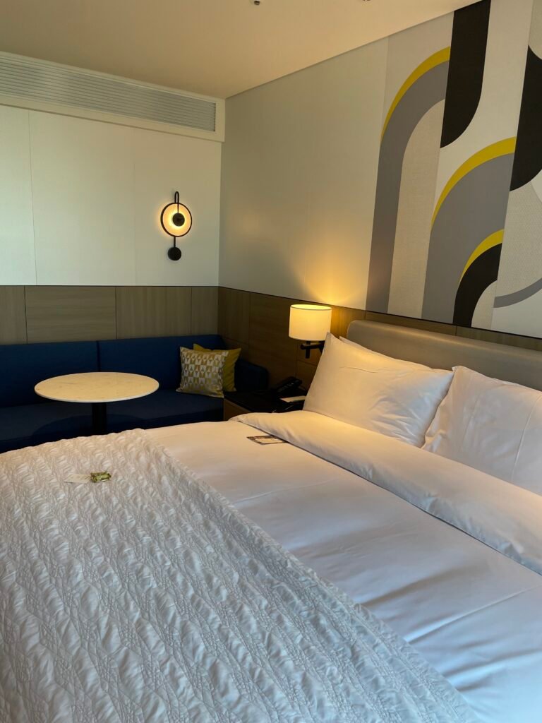 King bed and seating area in a Deluxe Room at Le Méridien Seoul Myeongdong