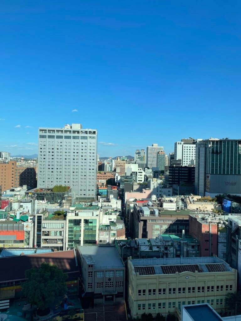 Daytime city view over Myeongdong from a high-floor Deluxe Room at Le Méridien Seoul Myeongdong