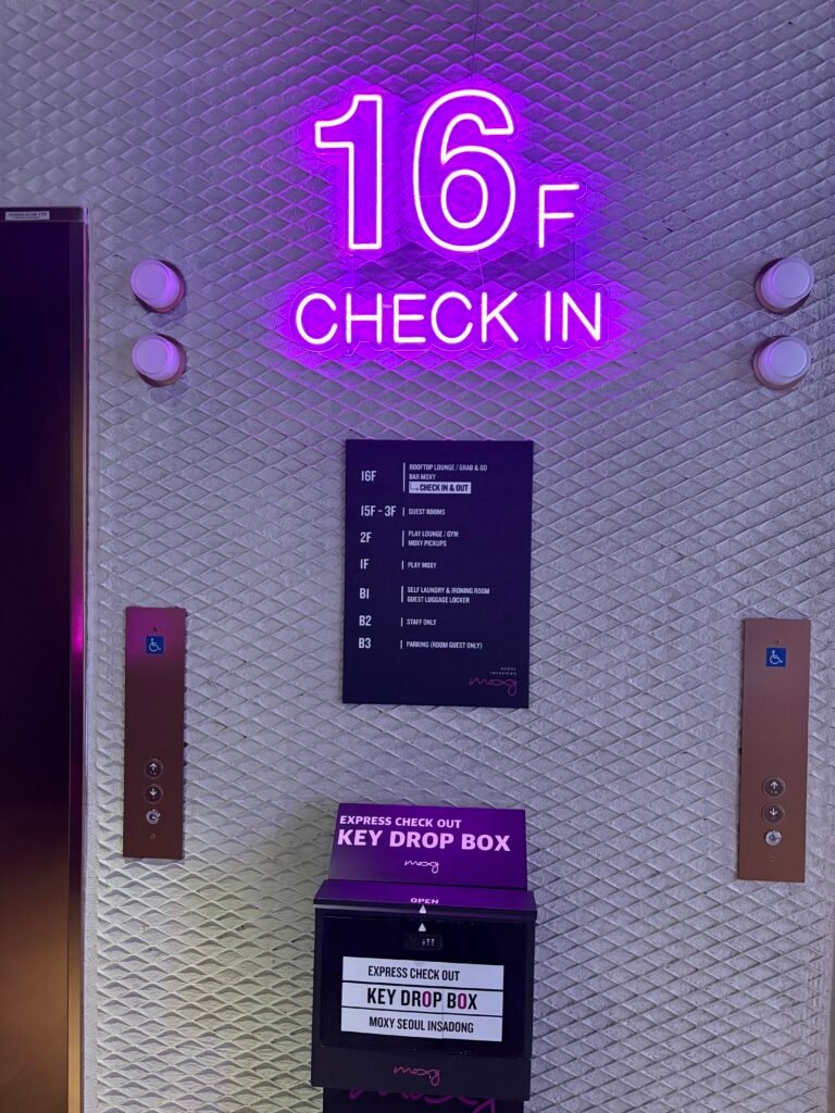 Sixteenth-floor check-in sign and floor directory at Moxy Seoul Insadong