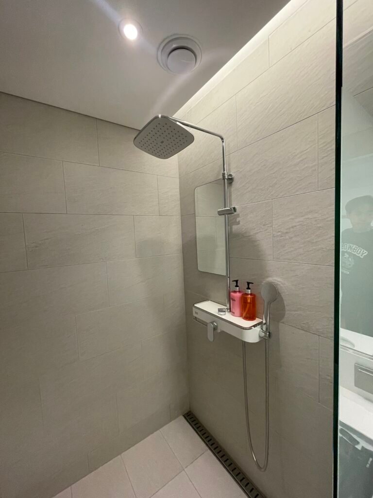 Walk-in shower in a guest bathroom at Moxy Seoul Insadong