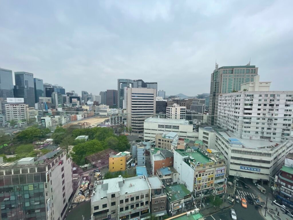 Daytime view over Jongno from a high-floor room at Moxy Seoul Insadong