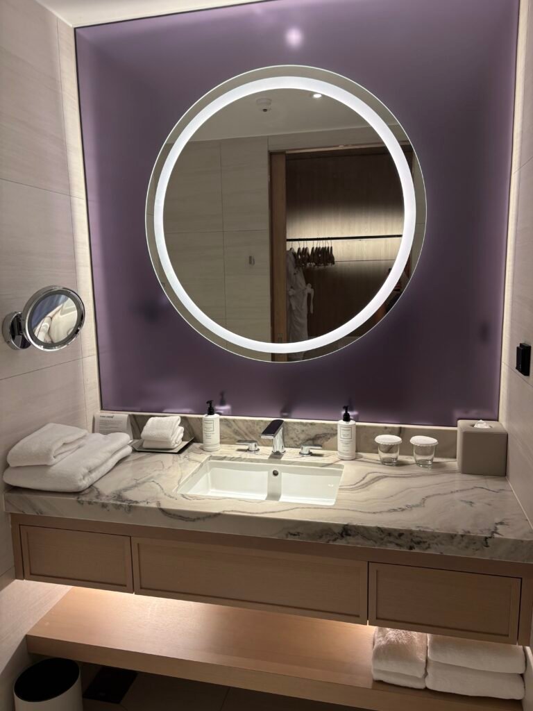 Spacious bathroom vanity with purple accents at The Link Seoul