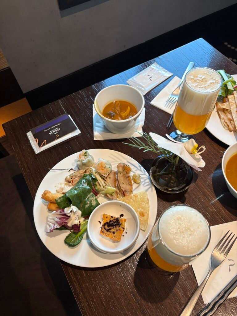 Plate of hot dishes and beer at THE PLAZA Seoul club lounge evening service