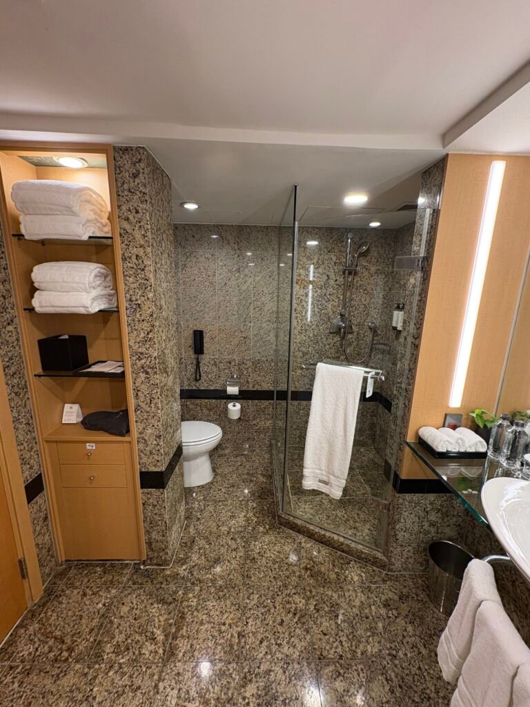 Main bathroom with a bathtub, sink, and separate glass shower enclosure