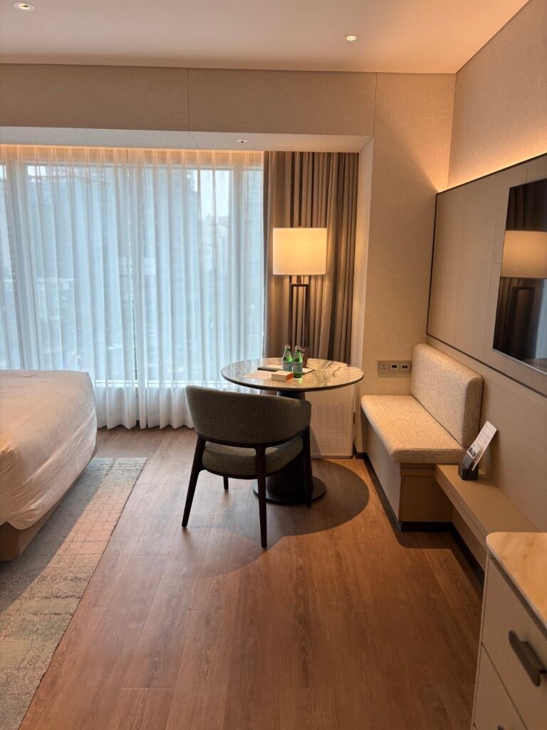 Twin guest room at The Westin Seoul Parnas with warm wood panelling and white beds