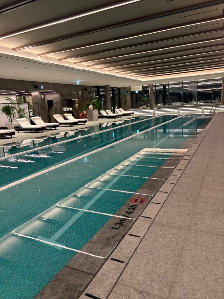 Indoor swimming pool at The Westin Seoul Parnas with three lap lanes and poolside loungers
