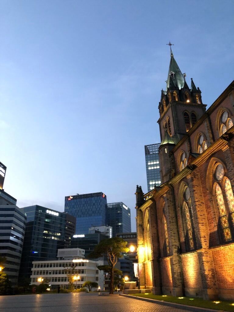 Myeongdong Cathedral at dusk with the central Seoul skyline