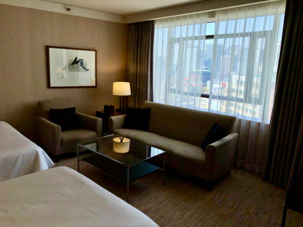 Guest room with bed and seating area at The Westin Josun Seoul