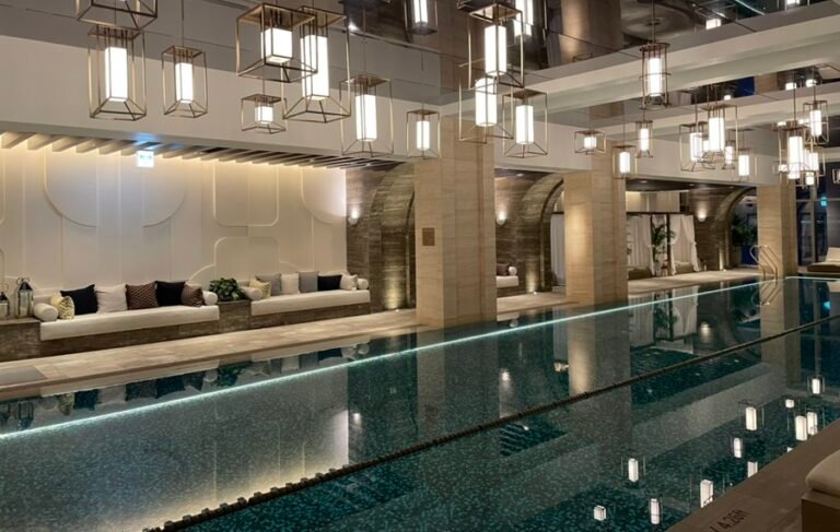 Indoor swimming pool at Josun Palace Seoul with mirrored ceiling and city views