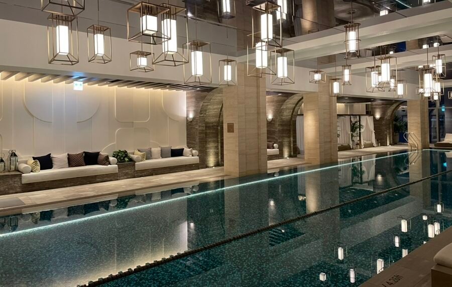 Indoor swimming pool at Josun Palace Seoul with mirrored ceiling and city views
