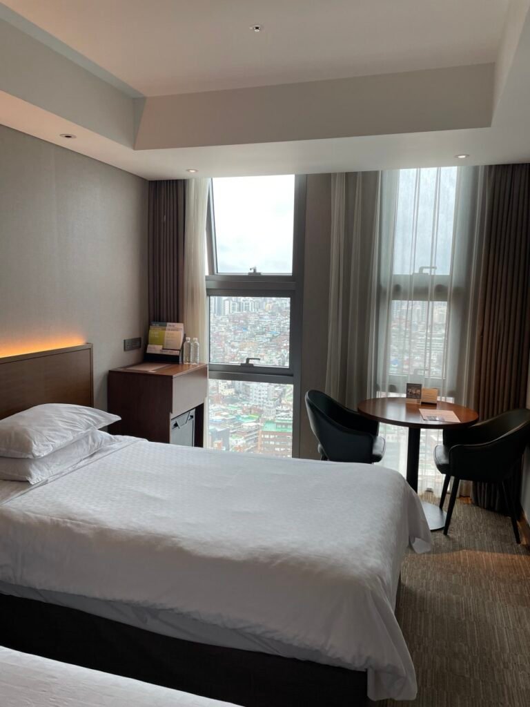Superior room interior with bed and window at Four Points Seoul Station