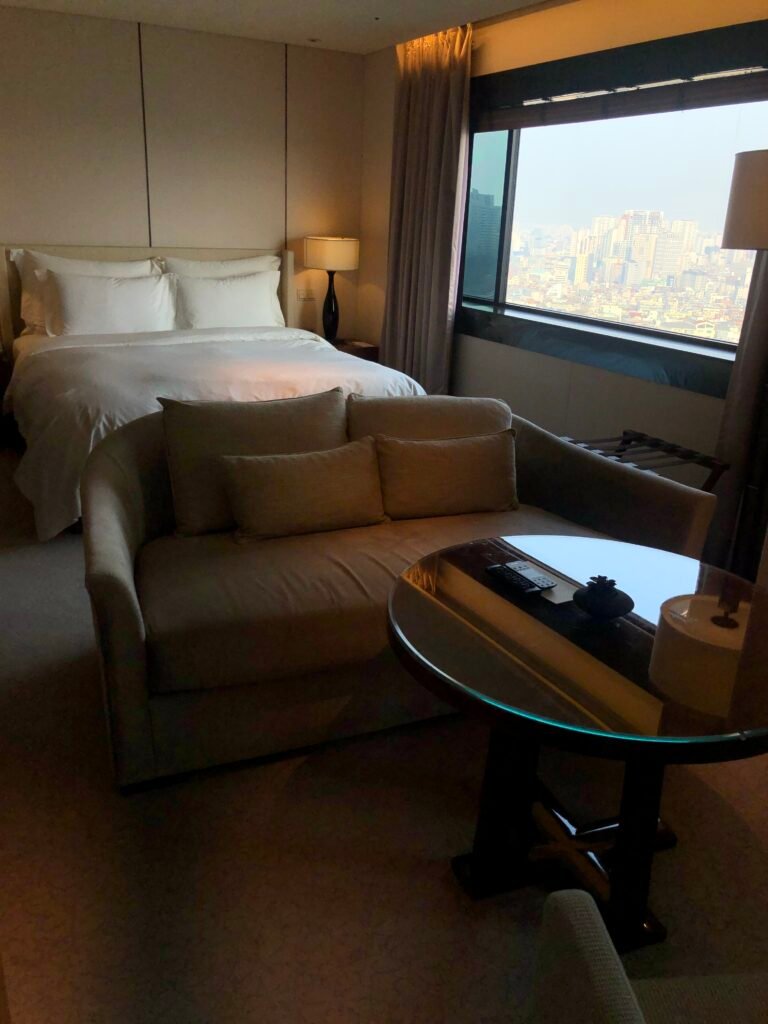 Executive Business Deluxe room at The Shilla Seoul with bed, sofa and window